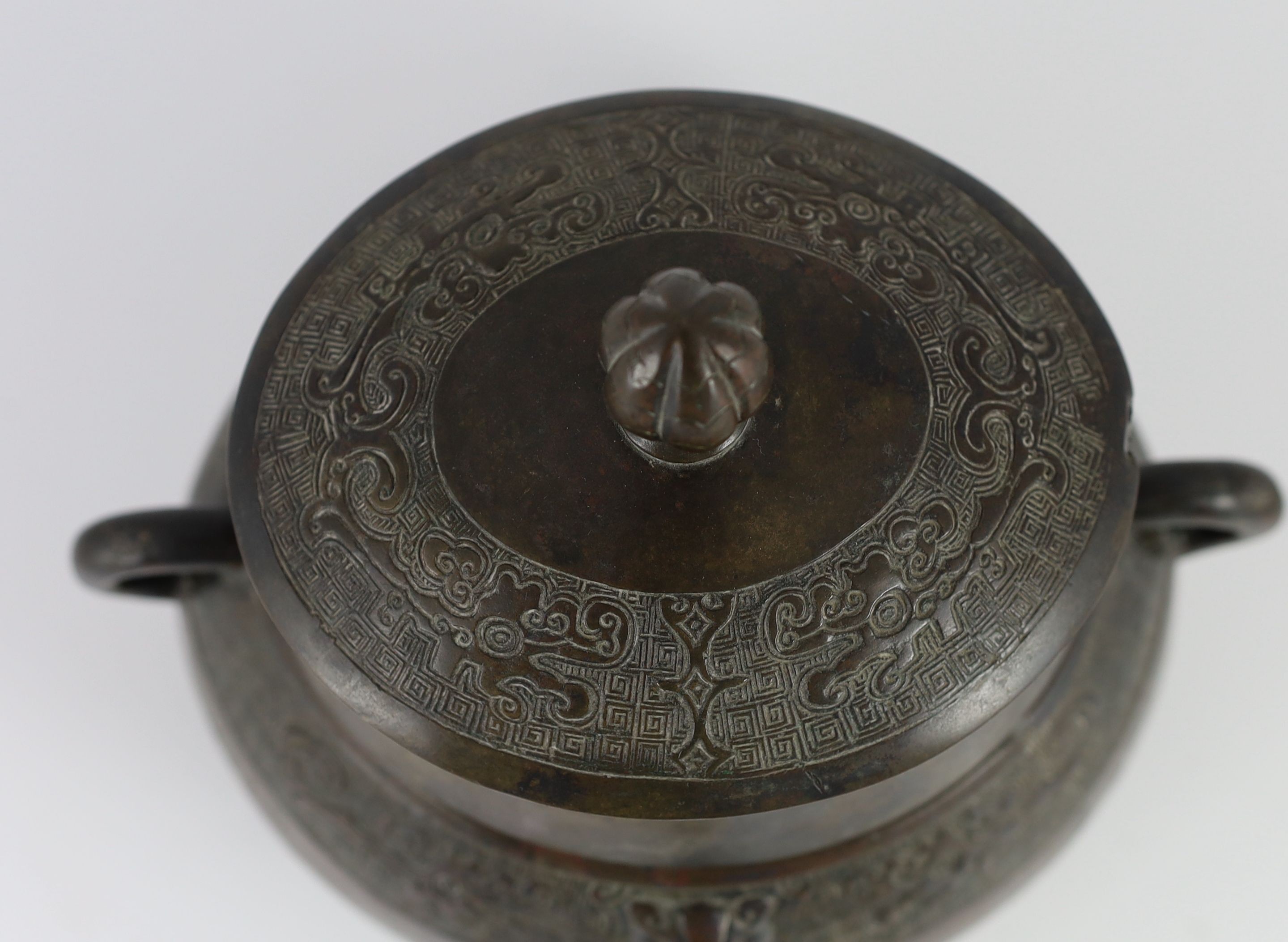A Chinese Ming bronze jar and cover, hu, 26cm high, old repairs